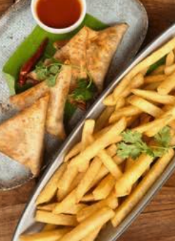 Samosas and French fries served with dipping sauce